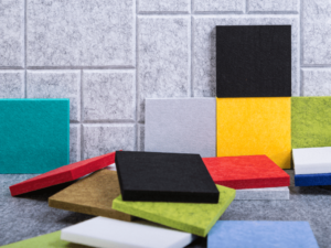Various colored acoustic foam panels arranged against a tiled wall.